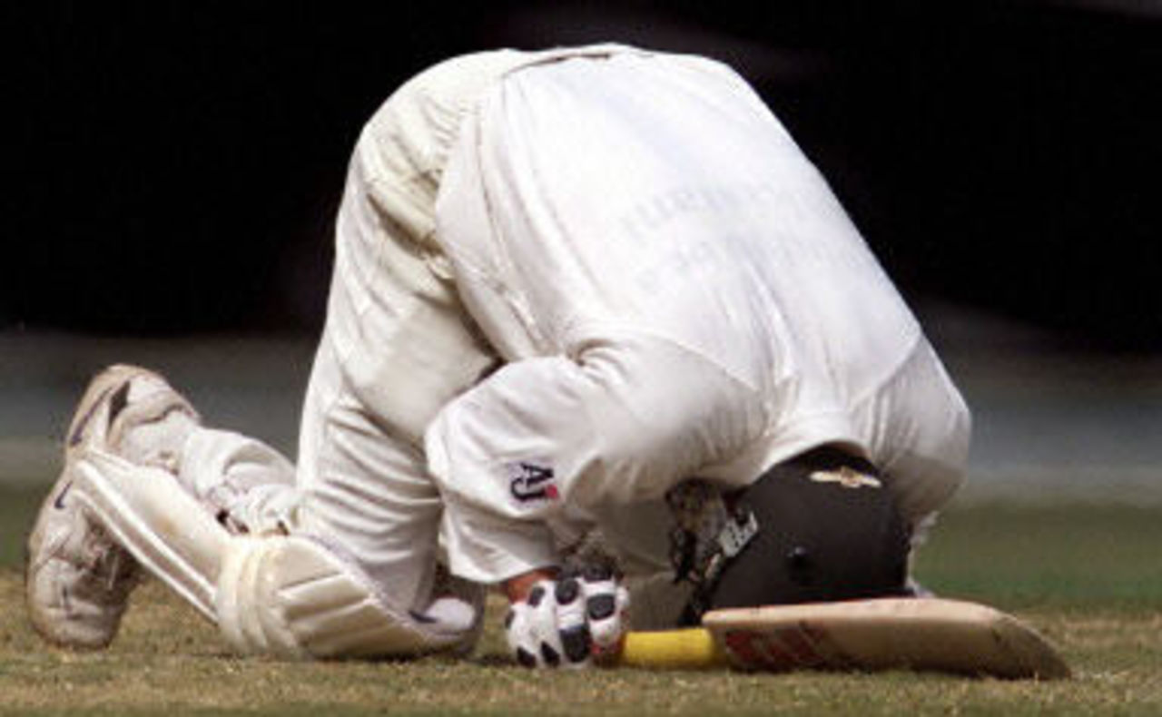 Younis Khan kneels on the ground after scoring his century, day 4, 1st Test at Eden Park in Auckland, 8-12 March 2001.