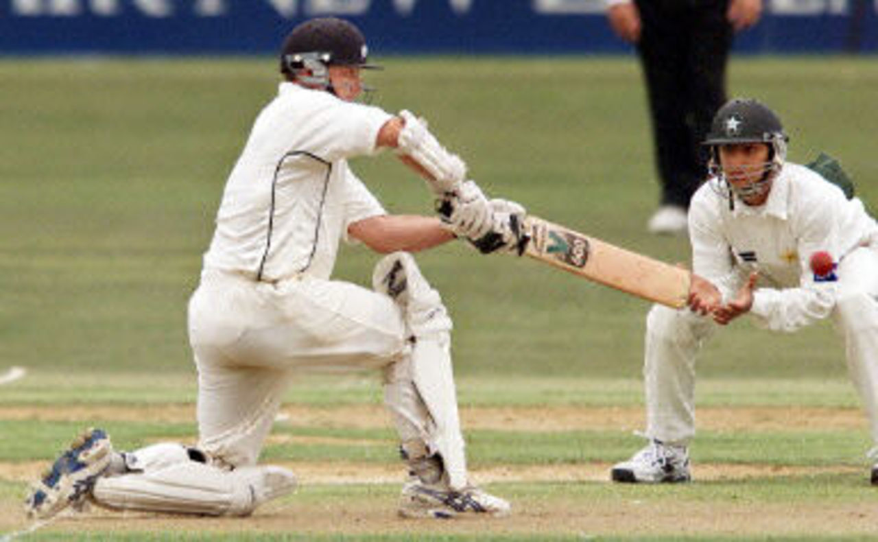 Mark Richardson sweeps a ball fine as Faisal Iqbal looks on, day 1, 3rd Test at Hamilton, 27-31 March 2001.