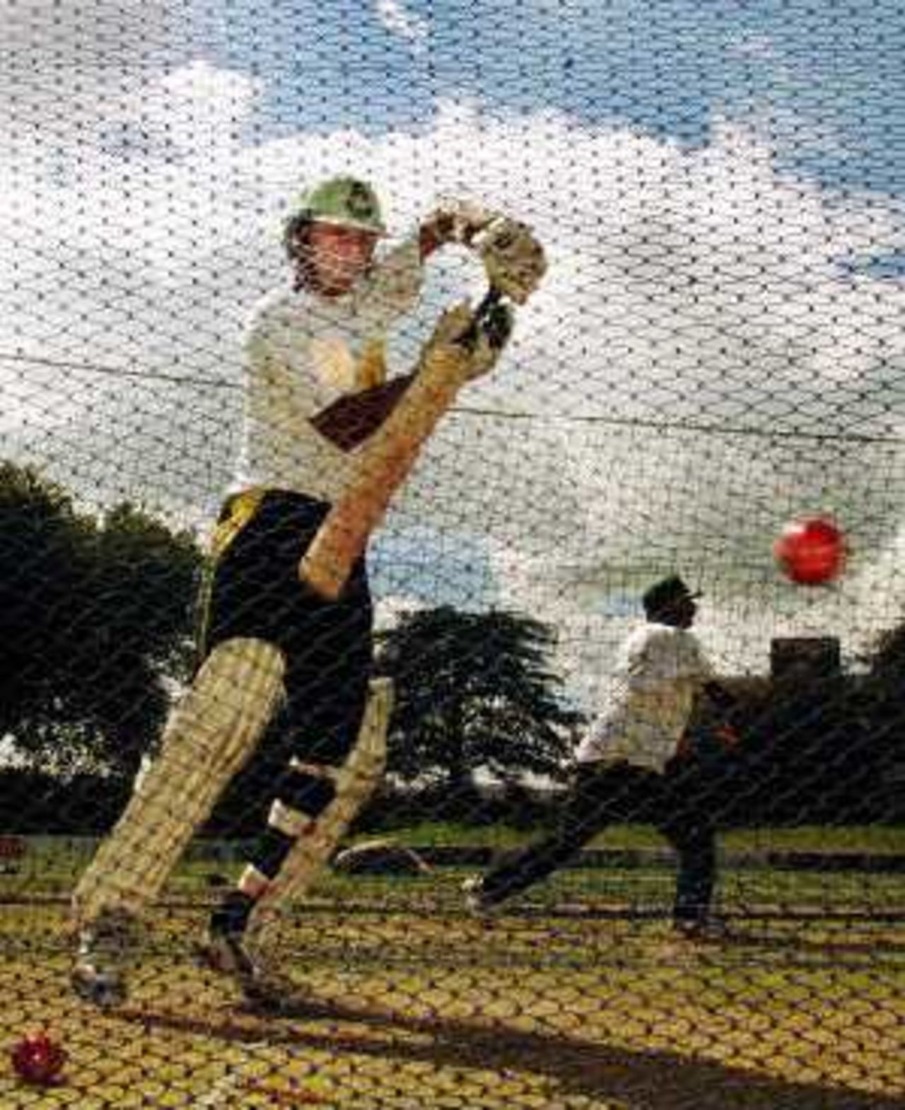 Faisal Iqbal plays a shot, as his uncle and coach Javed Miandad throws balls to a fellow batsman in the nets, day before, 3rd Test at Hamilton, 26 March 2001.