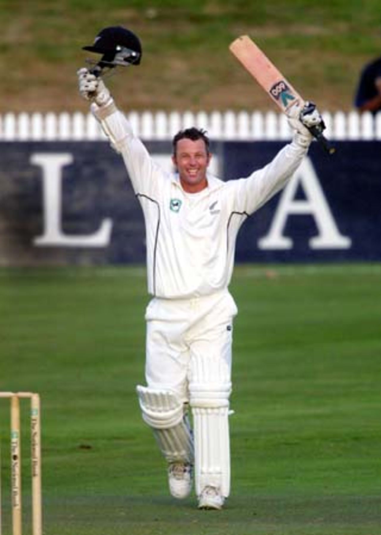 New Zealand opening batsman Mark Richardson raises his helmet and bat in celebration of reaching his maiden Test century. Richardson ended the third day's play on 106 not out in the first innings. 3rd Test: New Zealand v Pakistan at WestpacTrust Park, Hamilton, 27-31 March 2001 (Day 3).