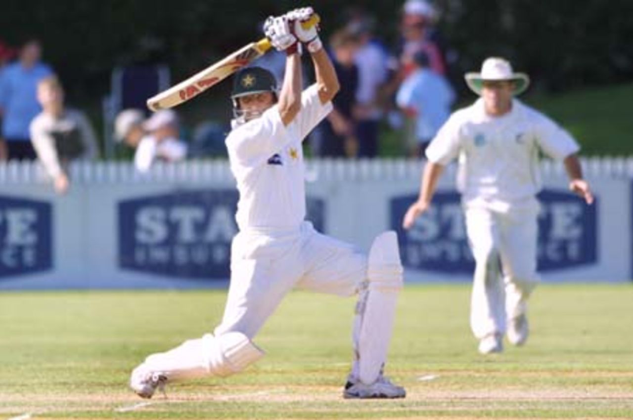 Pakistan batsman Younis Khan plays a square drive through backward point during his second innings of four while New Zealand fielder Mark Richardson looks on in the background. 3rd Test: New Zealand v Pakistan at WestpacTrust Park, Hamilton, 27-31 March 2001 (Day 4).