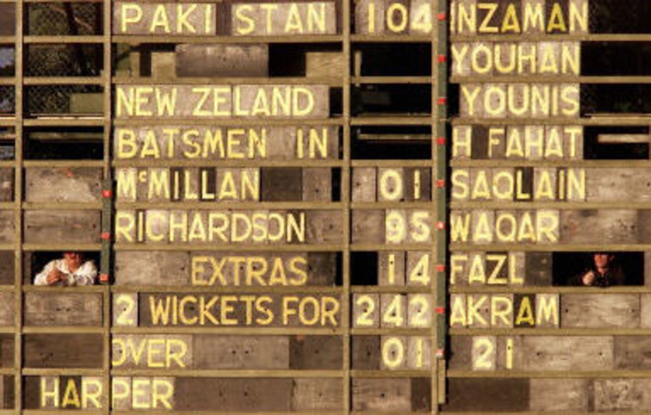Two scoreboard operators look out from the scoreboard which shows New Zealand well in control on the rain affected third day, day 3, third Test, Hamilton 30 March 2001.