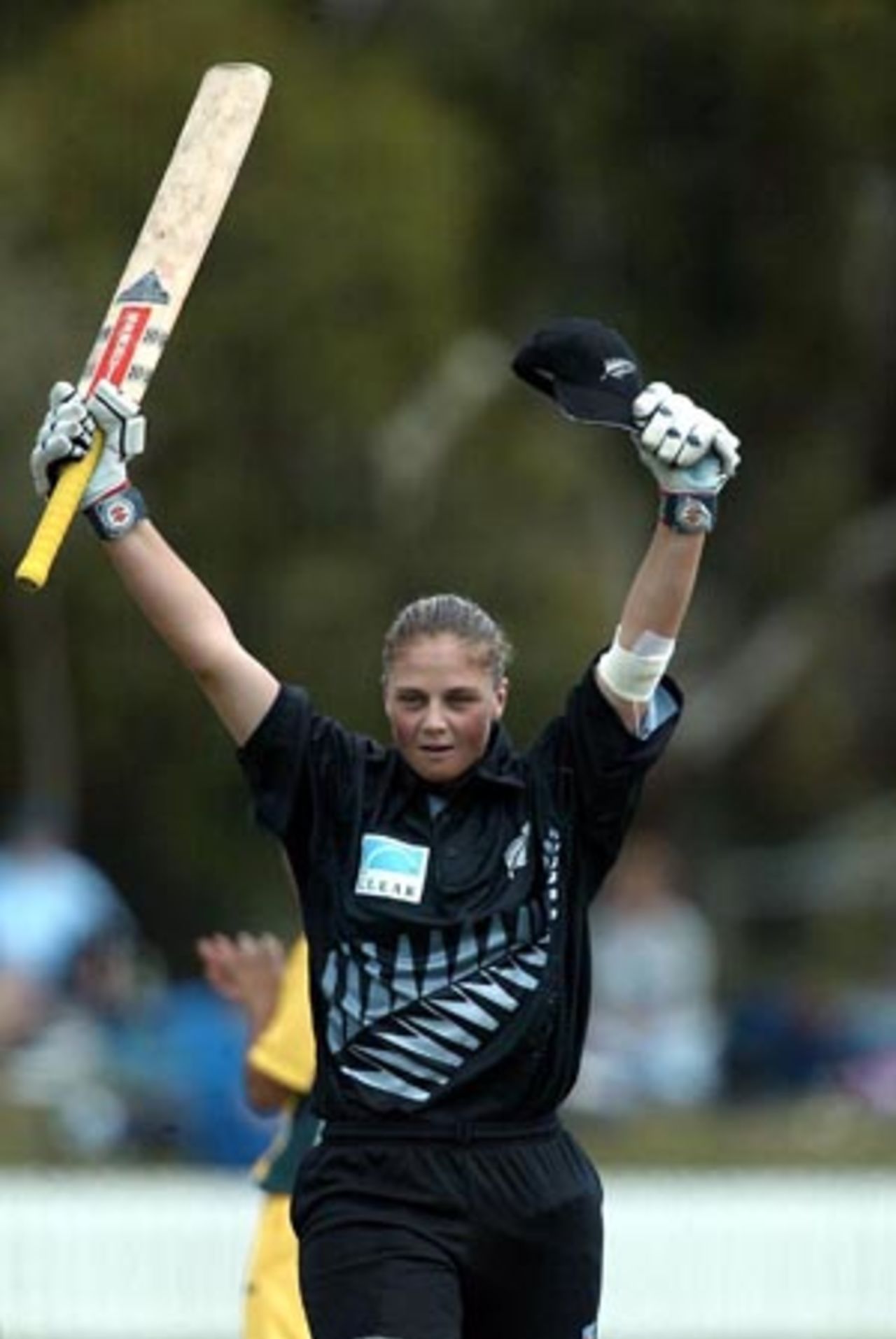 New Zealand Women batsman Rebecca Rolls raises her bat to celebrate her century. Rolls went on to score 114. 3rd WODI: New Zealand Women v Australia Women at Bert Sutcliffe Oval, Lincoln, 6 March 2002.