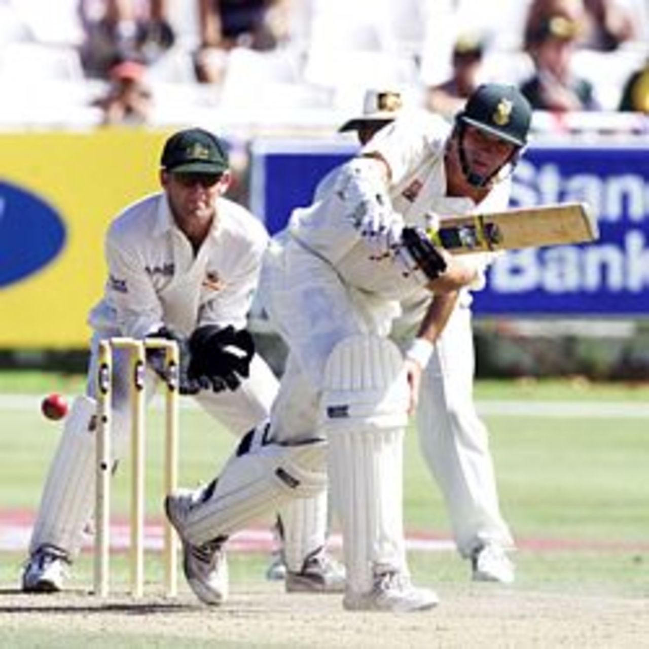 10 Mar 2002: Graeme Smith plays a shot as Adam Gilchrist looks on during the third day of the second test match between South Africa and Australia held at Newlands.