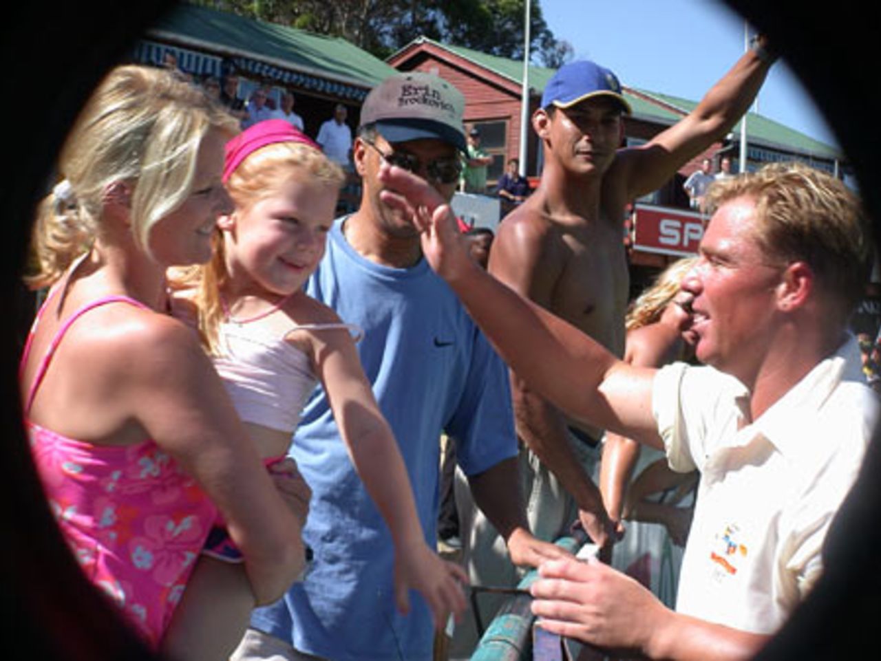 Shane Warne greets his wife Simone and daughter Brooke