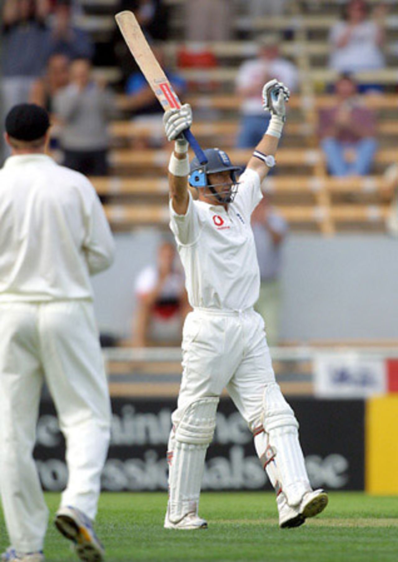 England batsman Nasser Hussain raises his bat to celebrate reaching his century. Hussain went on to score 106 in his first innings. 1st Test: New Zealand v England at Jade Stadium, Christchurch, 13-17 March 2002 (13 March 2002).