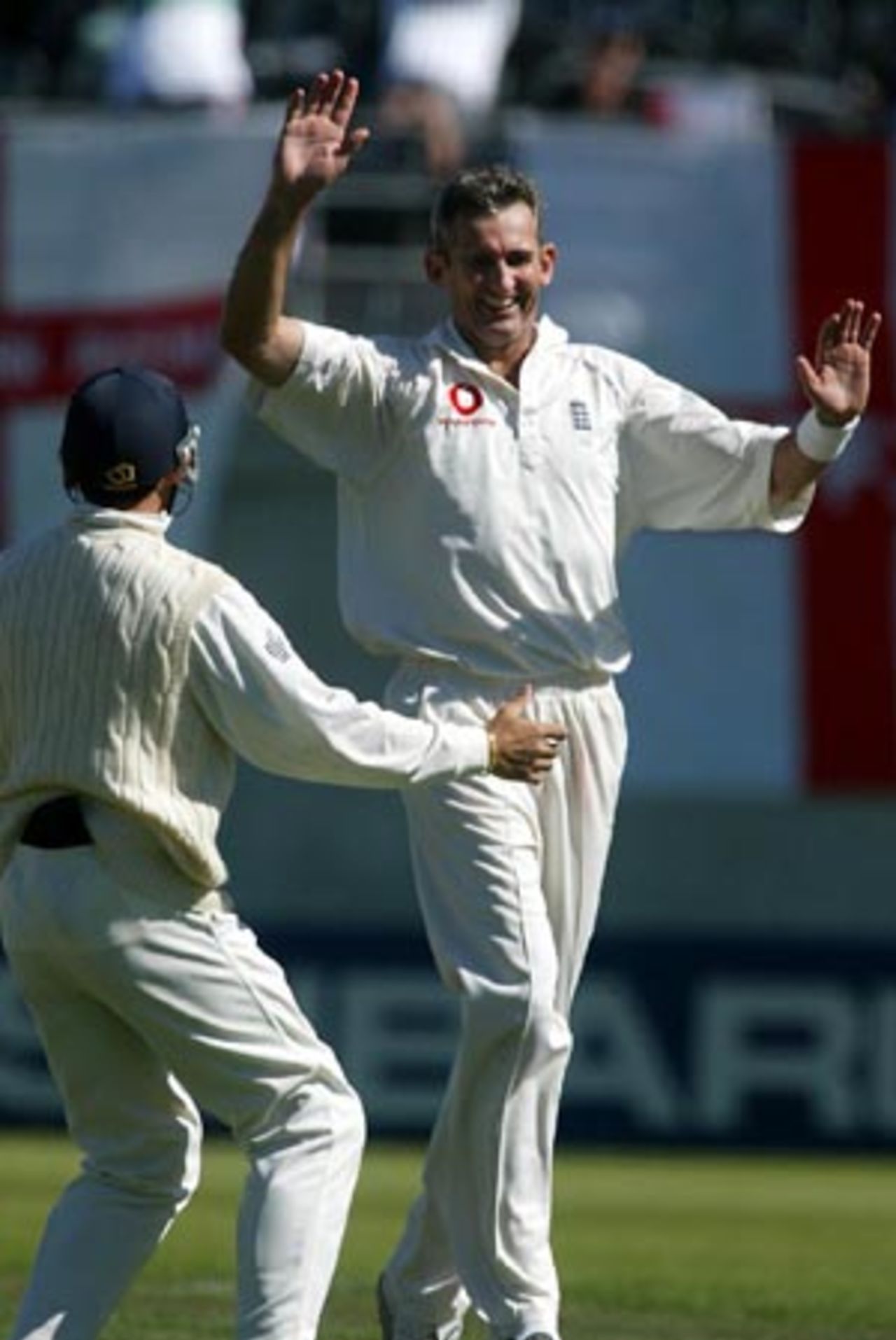 England bowler Andy Caddick celebrates the dismissal of New Zealand batsman Chris Cairns, caught by Andrew Flintoff for 0. Mark Ramprakash congratulates him. 1st Test: New Zealand v England at Jade Stadium, Christchurch, 13-17 March 2002 (14 March 2002).