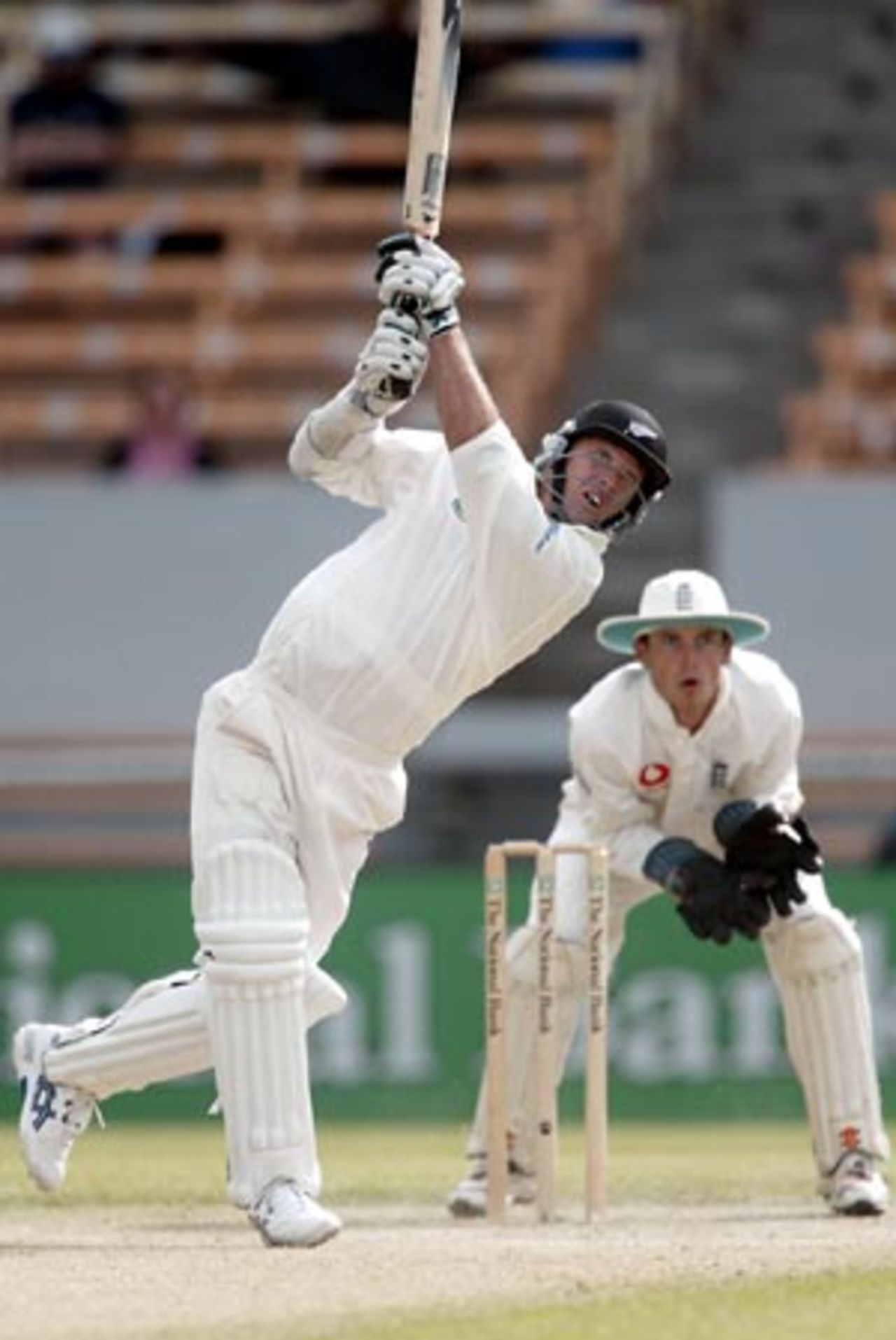 New Zealand batsman Mark Richardson lofts a delivery from England bowler Ashley Giles to the long off boundary while wicket-keeper James Foster looks on. Richardson scored 76 in his second innings. 1st Test: New Zealand v England at Jade Stadium, Christchurch, 13-17 March 2002 (16 March 2002).