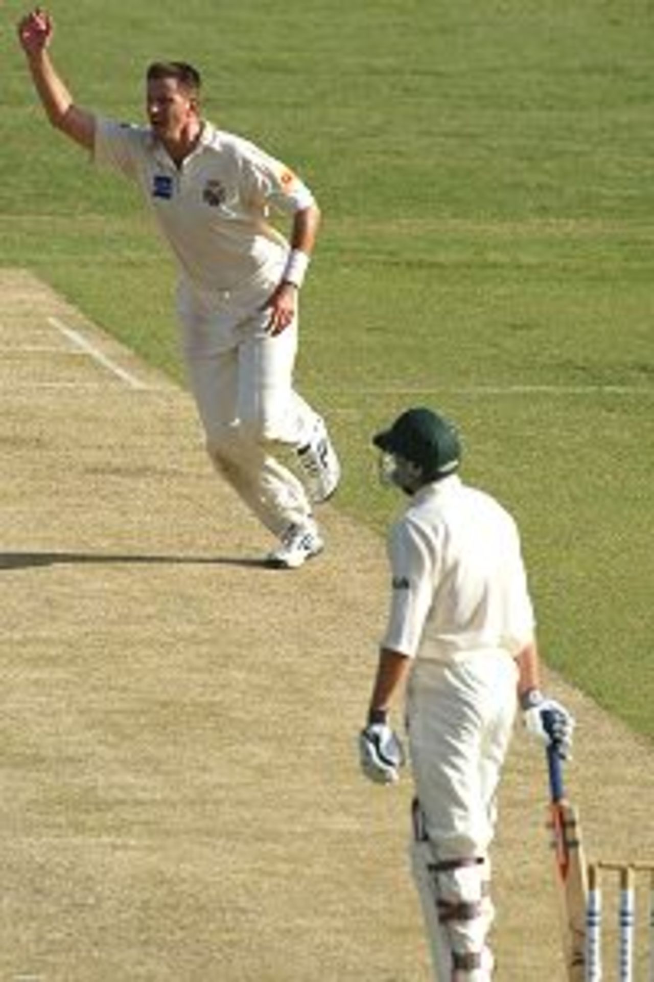 23 Mar 2002: Michael Kasprowicz of Queensland celebrates as he claims the wicket of Scott Kremerskothen of Tasmania, caught by substitute fieldsman, Clinton Perren for ten, during day two of the Pura Cup Final between the Queensland Bulls and the Tasmania Tigers, played at the Gabba, Brisbane, Australia.