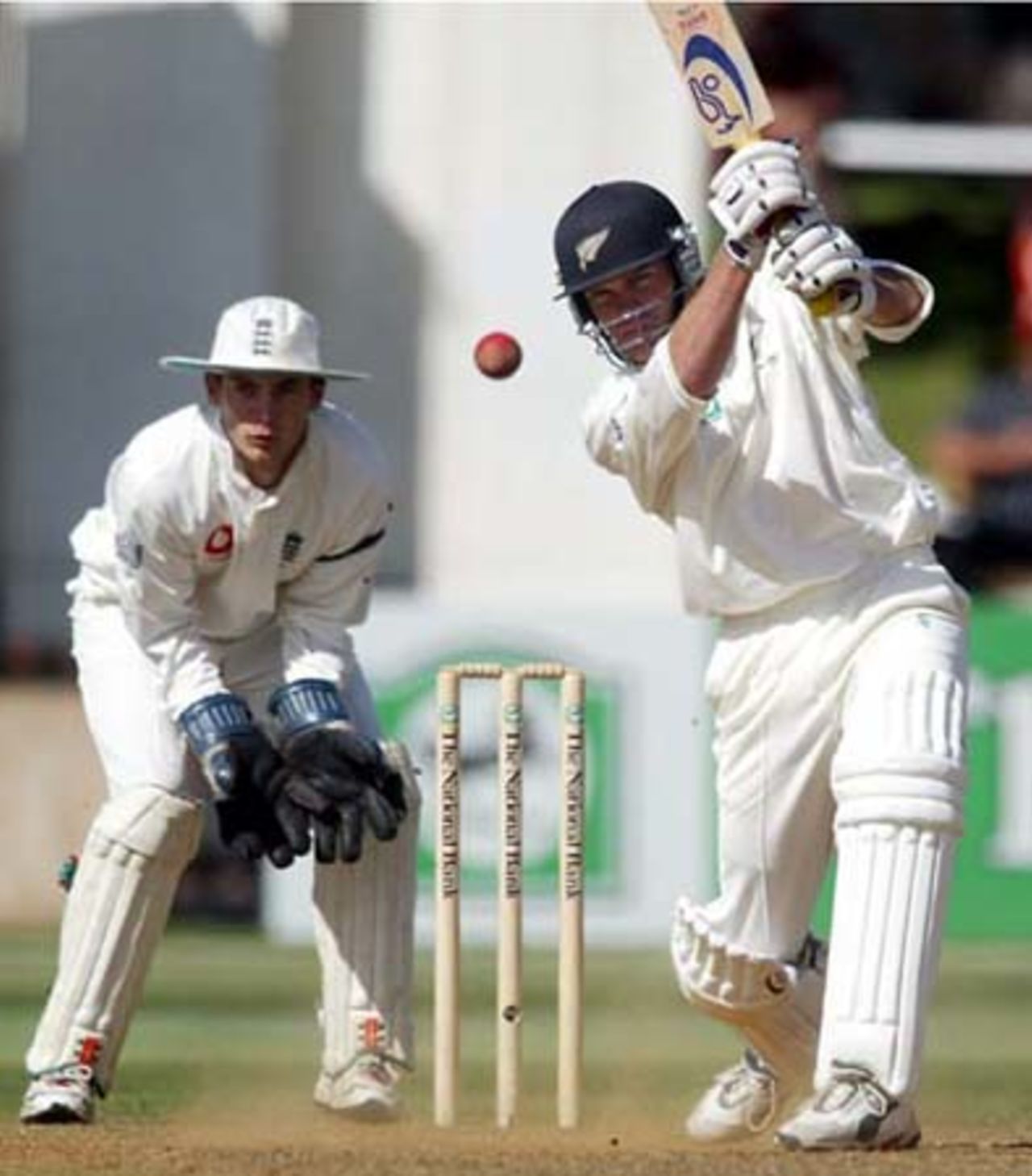 New Zealand batsman Lou Vincent drives a delivery from England bowler Ashley Giles down the ground as wicket-keeper James Foster looks on. Vincent scored 57 in his first innings. 2nd Test: New Zealand v England at Basin Reserve, Wellington, 21-25 March 2002 (24 March 2002).