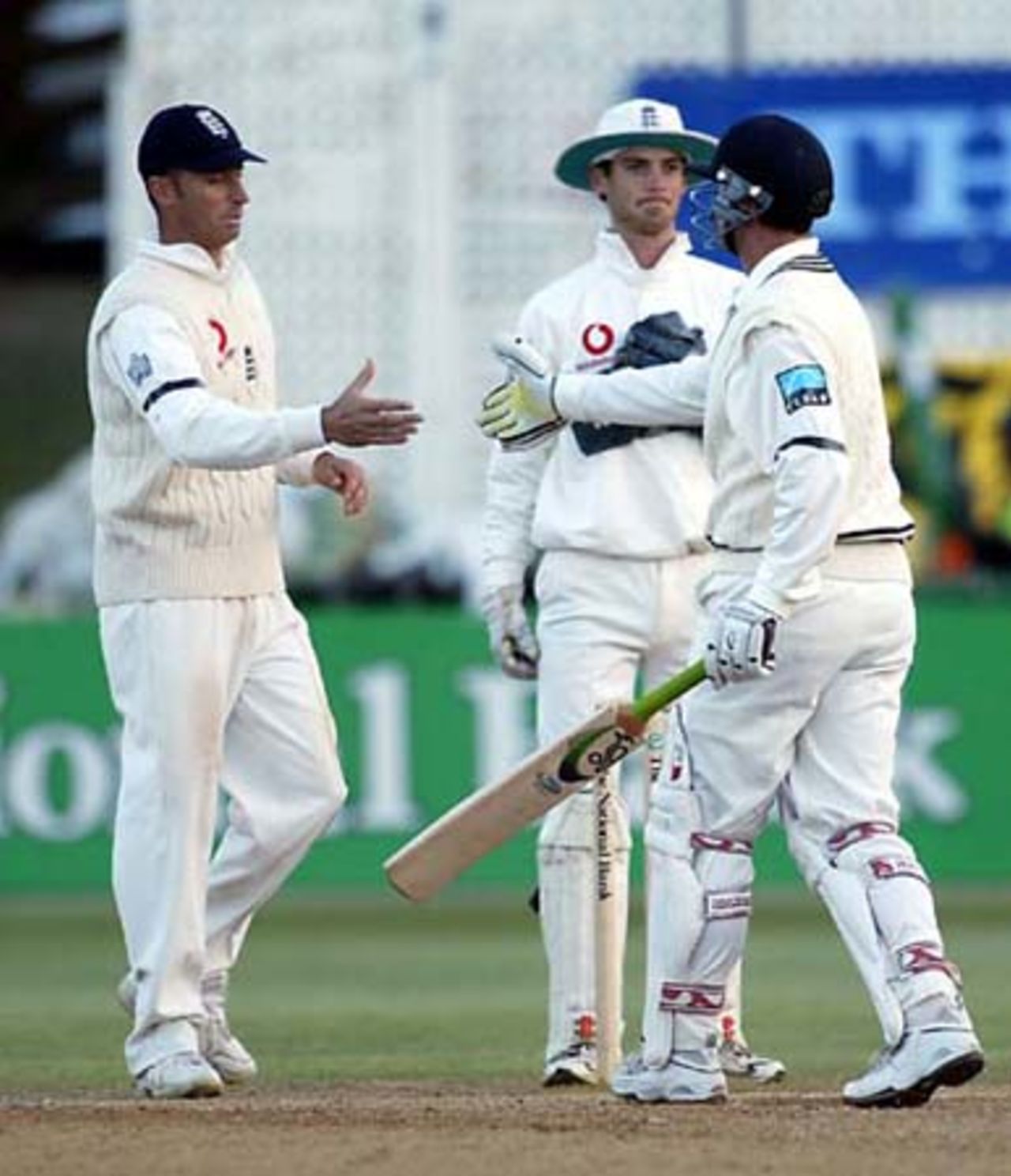 England captain Nasser Hussain and New Zealand batsman Astle shake hands at the end of the match while wicket-keeper James Foster looks on. 2nd Test: New Zealand v England at Basin Reserve, Wellington, 21-25 March 2002 (25 March 2002).