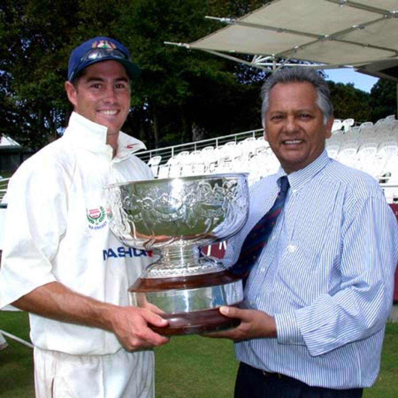 WP Bowl captain Jonathan McLean receives the UCB Bowl from WP Cricket Vice-President Sadick Emeran