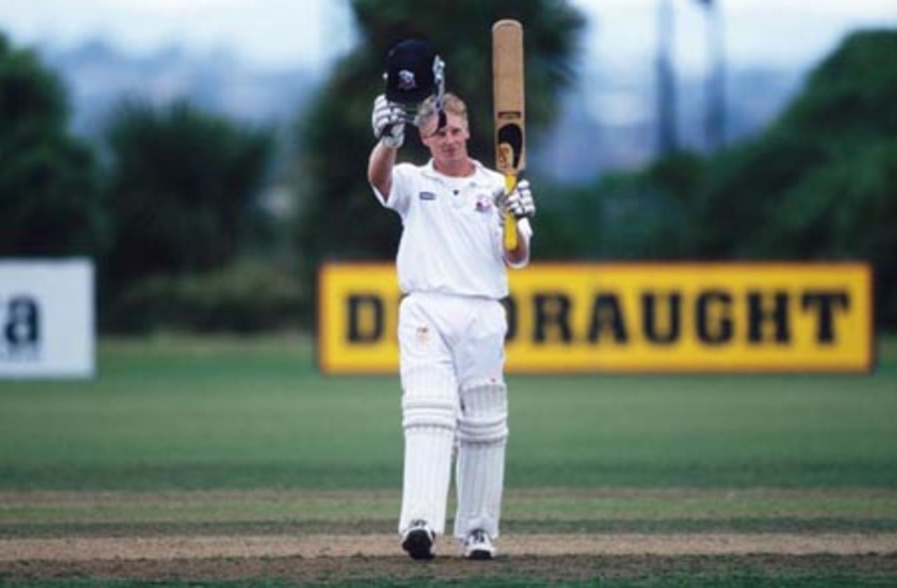 Auckland batsman Nick Horsley raises his helmet and bat to celebrate reaching his century. Horsley went on to score X not out in his second innings. State Championship: Auckland v Wellington at Colin Maiden Park, Auckland, 24-27 March 2002 (27 March 2002).