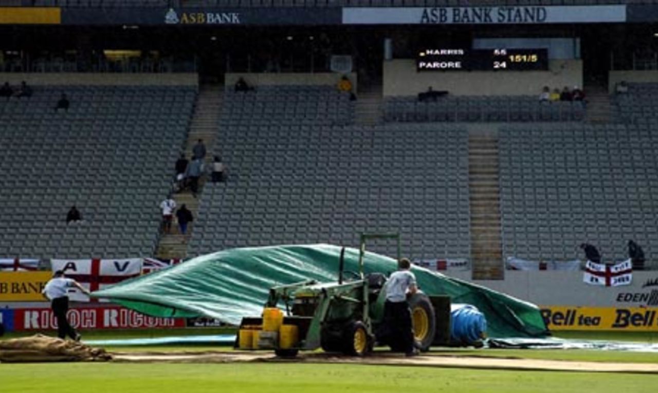 Ground staff put on the covers as showers fall at the ground on the third morning. 3rd Test: New Zealand v England at Eden Park, Auckland, 30 March-3 April 2002 (1 April 2002).