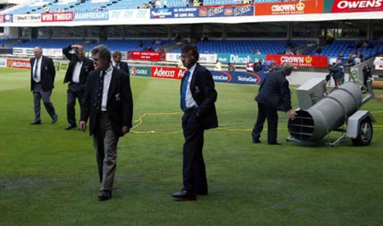 Match officials check the condition of wet patches in the outfield on the third morning. They are match referee Jackie Hendriks (back left), third umpire Tony Hill, umpires Doug Cowie (front left) and Srinivas Venkataraghavan from India. 3rd Test: New Zealand v England at Eden Park, Auckland, 30 March-3 April 2002 (1 April 2002).