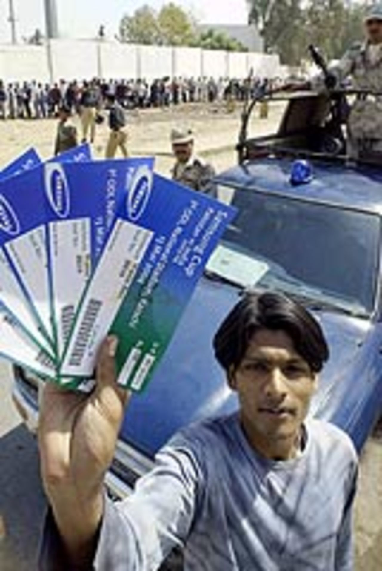 A cricket fan in Karachi with tickets for the first ODI between India and Pakistan, March 8, 2004