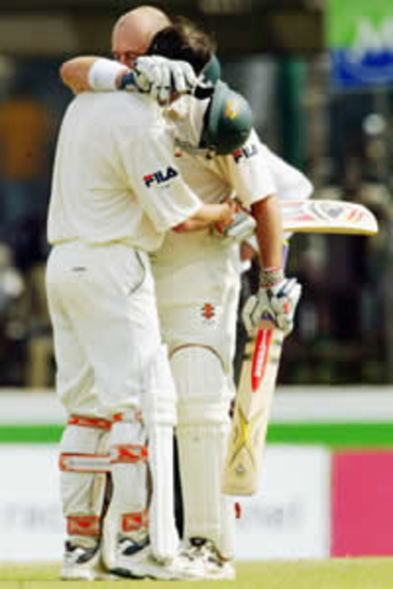 Darren Lehmann of Austrralia feels the emotion of his century with team mate Damien Martyn during day four of the First Test between Australia and Sri Lanka played at the Galle International Cricket Stadium on March 11, 2004 in Galle, Sri Lanka