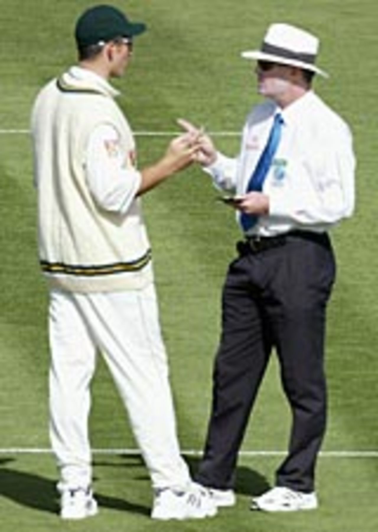 Graeme Smith and Russell Tiffin exchange views after Andre Nel had been warned for running down the wicket, New Zealand v South Africa, Hamilton, 1st Test, March 11, 2004