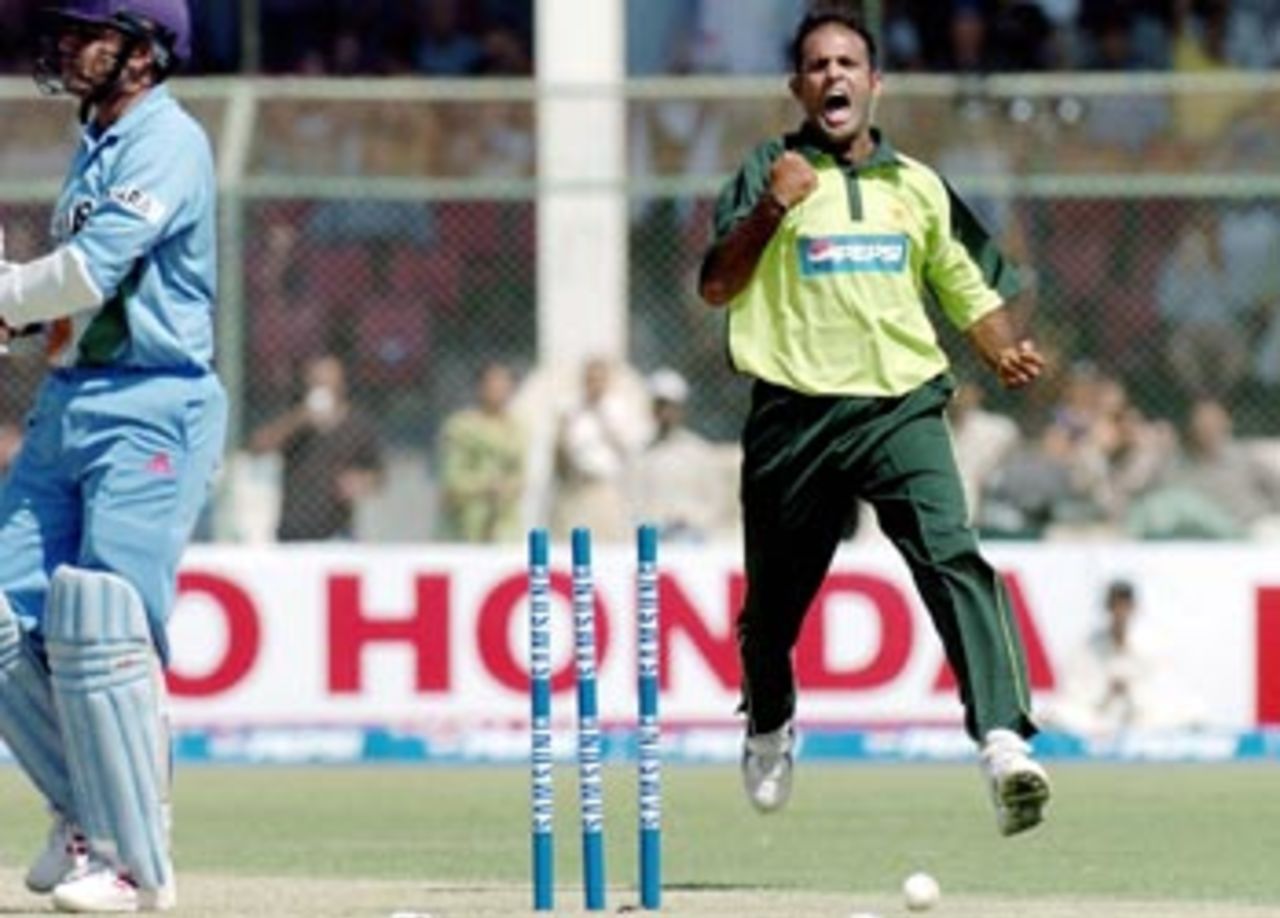 Pakistani pace bowler Naved-ul-Hasan celebrates after bowling out Indian batsman Virender Sehwag