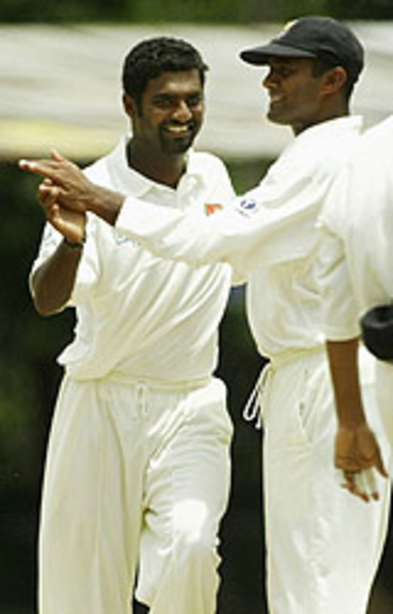Muttiah Muralitharan slaps hands after dismissing a batsman, Sri Lanka v Australia, 2nd Test, Kandy, 1st day, March 16, 2004