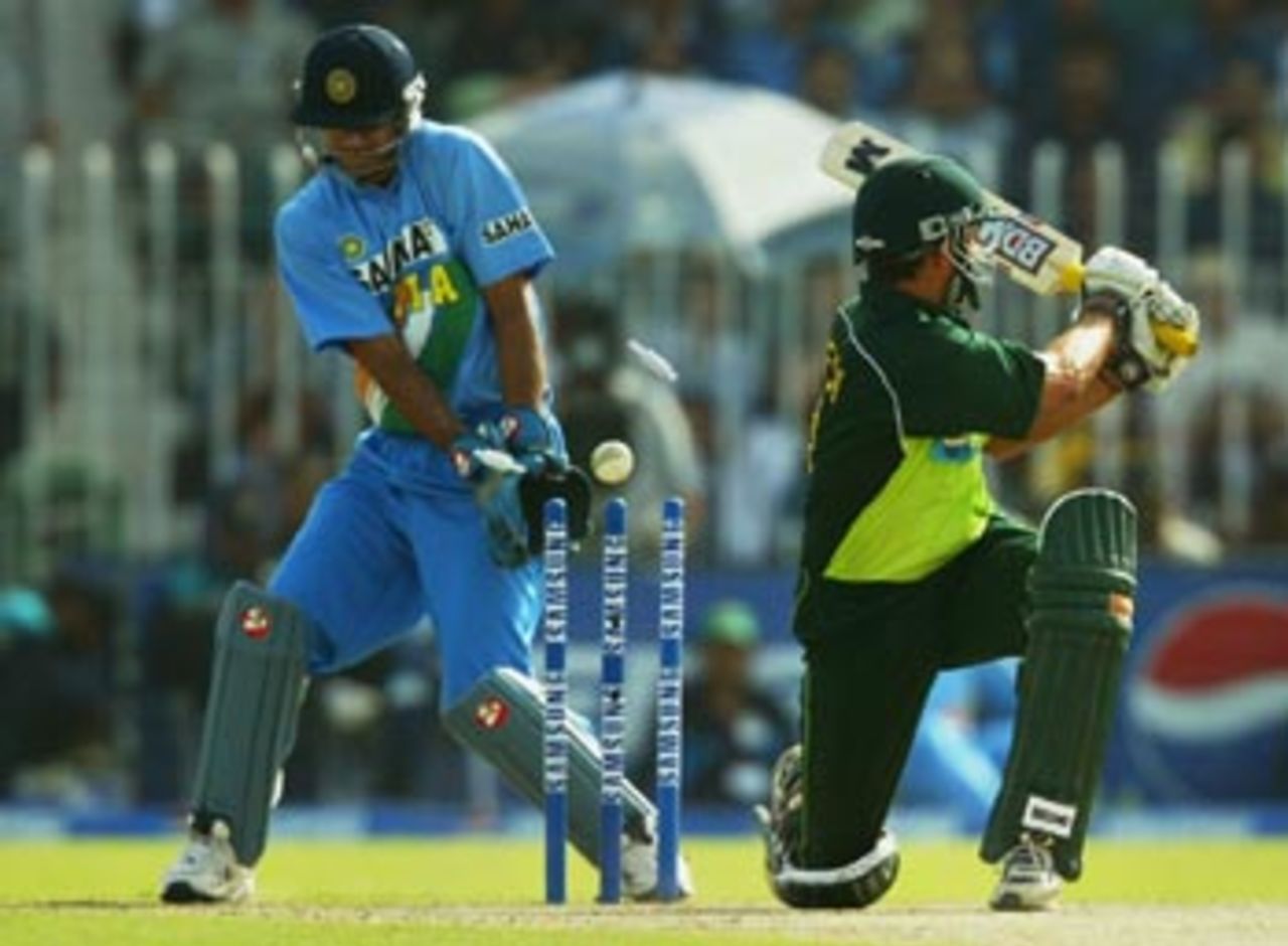 Shahid Afridi of Pakistan is bowled for 80 as wicketkeeper Rahul Dravid watches
