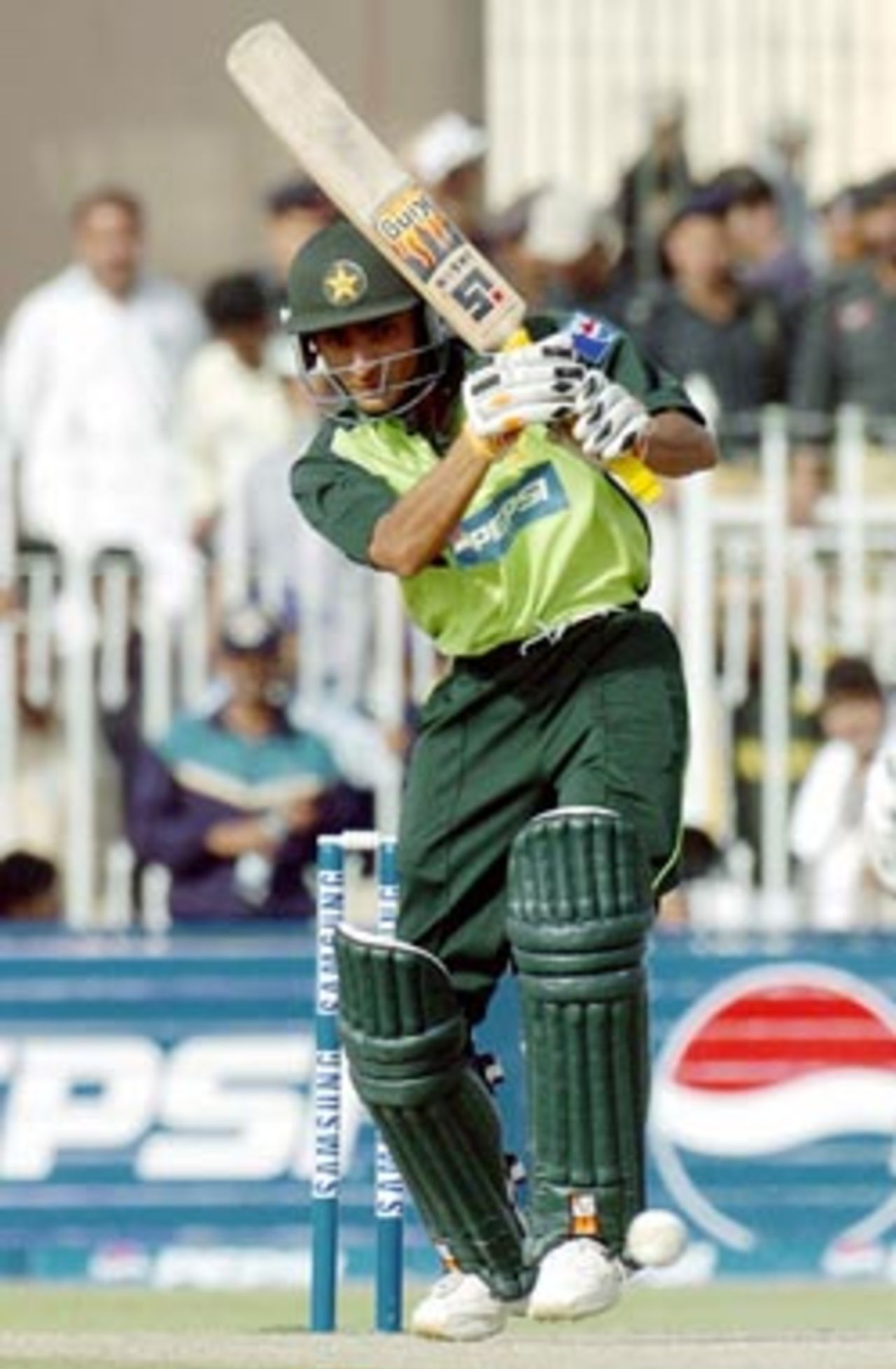 Pakistani batsman Yasir Hameed hits a ball off Indian pace bowler Ashish Nehra