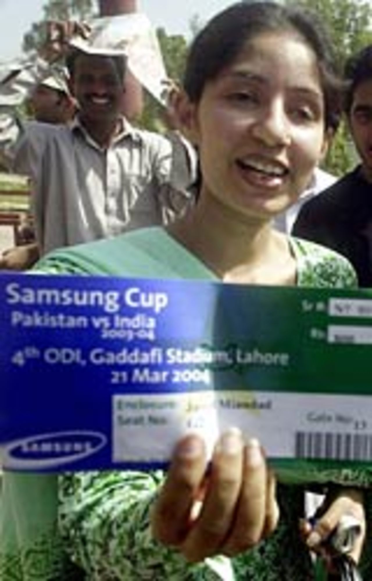 One of the lucky few: a fan clutches a ticket for Sunday's ODI at Lahore, March 17, 2004