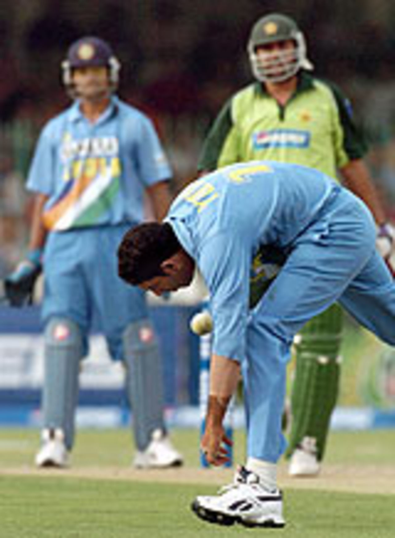 Yuvraj Singh stops a ball on his follow-through, watched by Inzamam-ul-Haq and Rahul Dravid, Pakistan v India, 4th ODI, Lahore, March 21, 2004