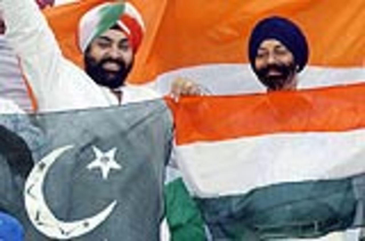Indians fans hold the flags of India and Pakistan during the final ODI at Lahore, March 24, 2004