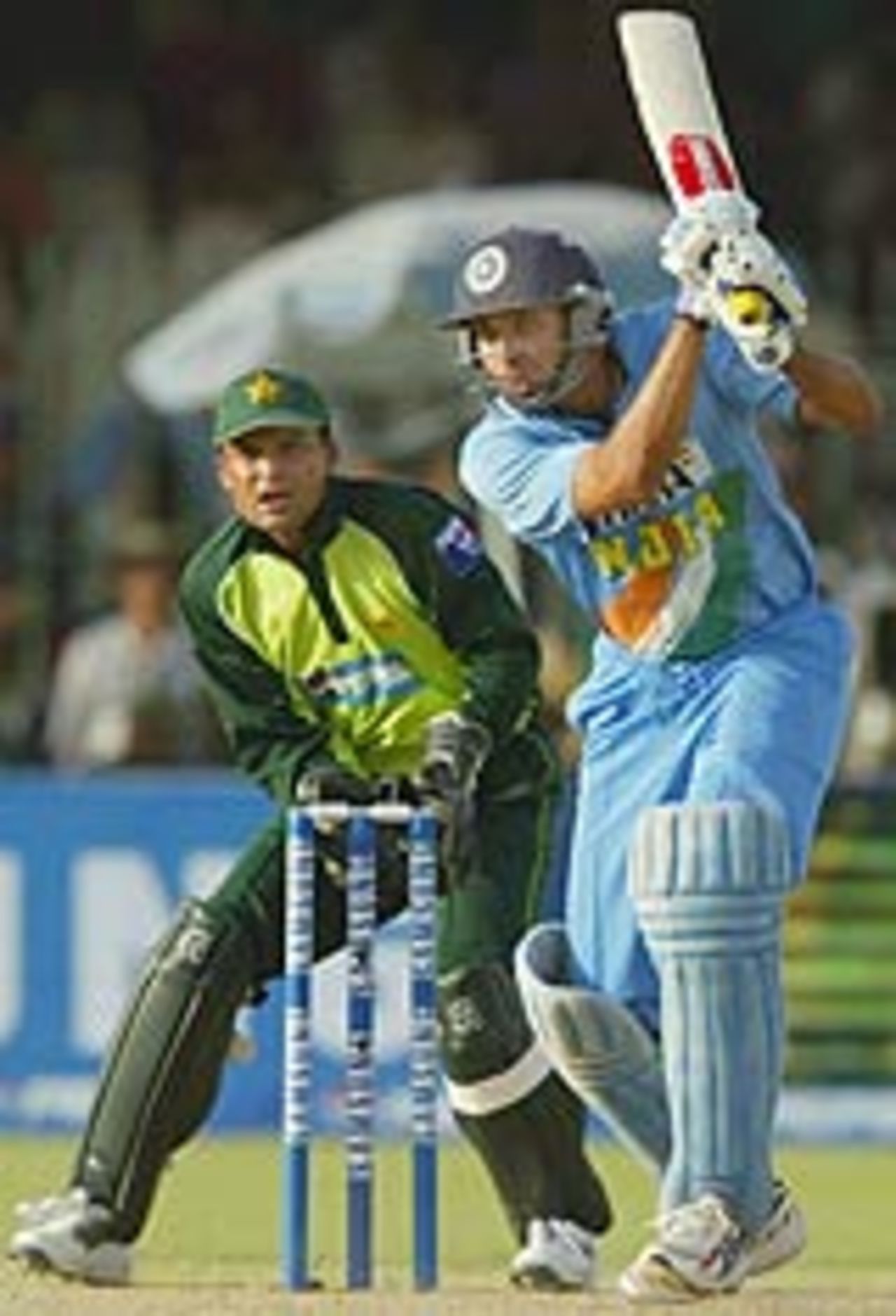 VVS Laxman launches into a cover-drive as Moin Khan watches, Pakistan v India, 5th ODI, Lahore, March 24, 2004