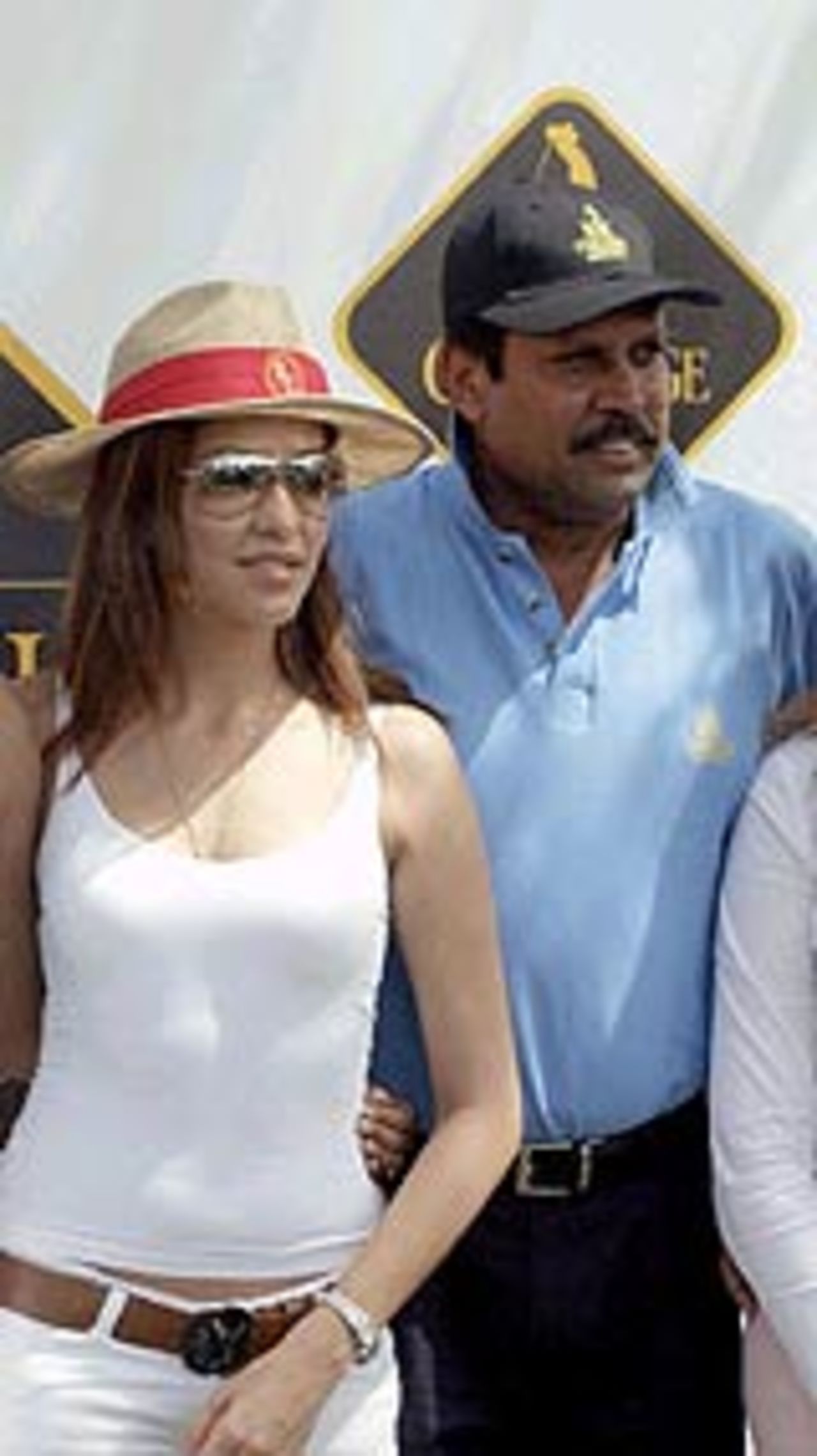 Kapil Dev and Aditi Govitrikar, an Indian model, at a golf tournament in New Delhi, March 23, 2004