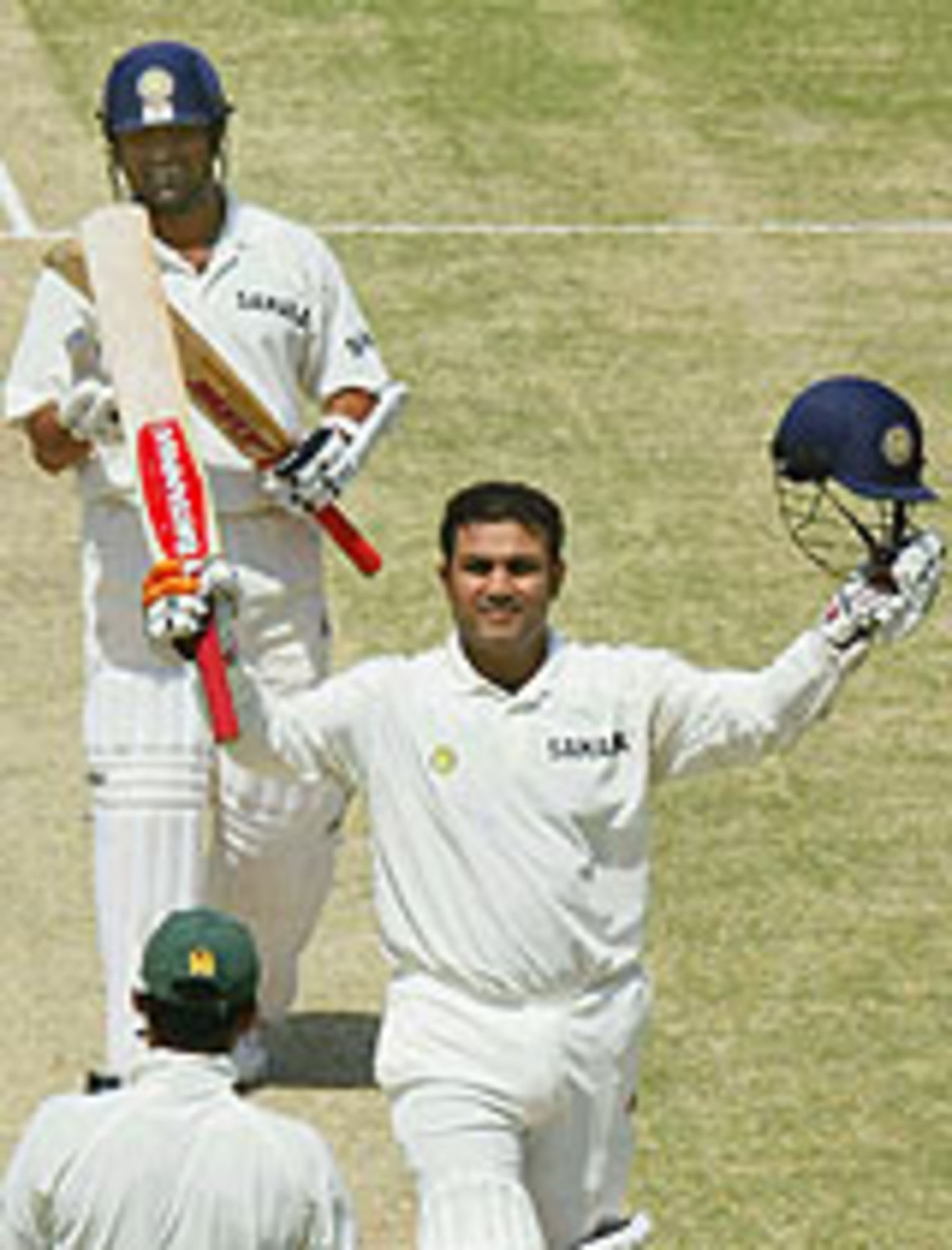 Virender Sehwag, watched by Sachin Tendulkar, acknowledges the applause for his triple-century, Pakistan v India, 1st Test, Multan, 2nd day, March 29, 2004