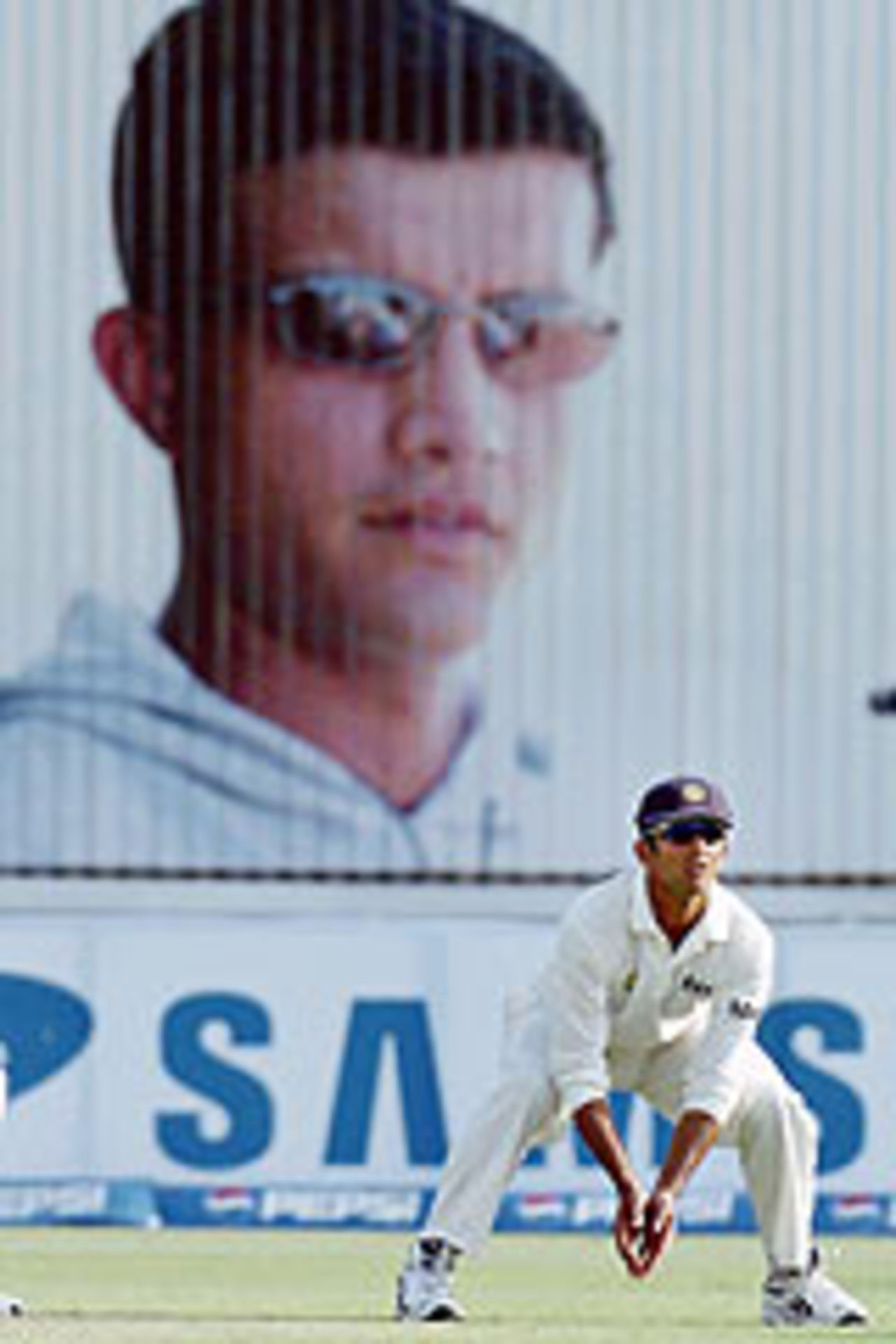 Rahul Dravid fields in the backdrop of a hoarding with Sourav Ganguly's face on it, Pakistan v India, 1st Test, Multan, 3rd day, March 30, 2004