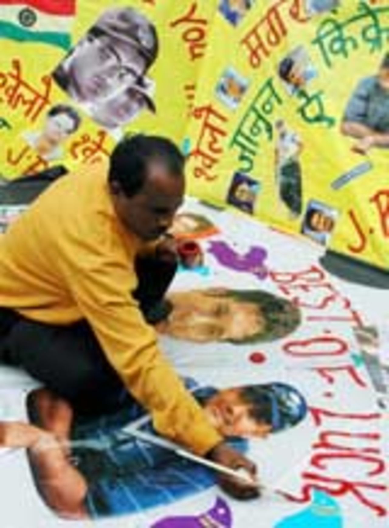 A painter puts the finishing touches on a 'good-luck' kite