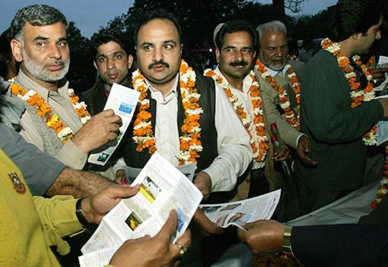 Pakistan cricket fans looking at information booklets on India after arriving by bus in Chandigarh for the first Test, March 7, 2005