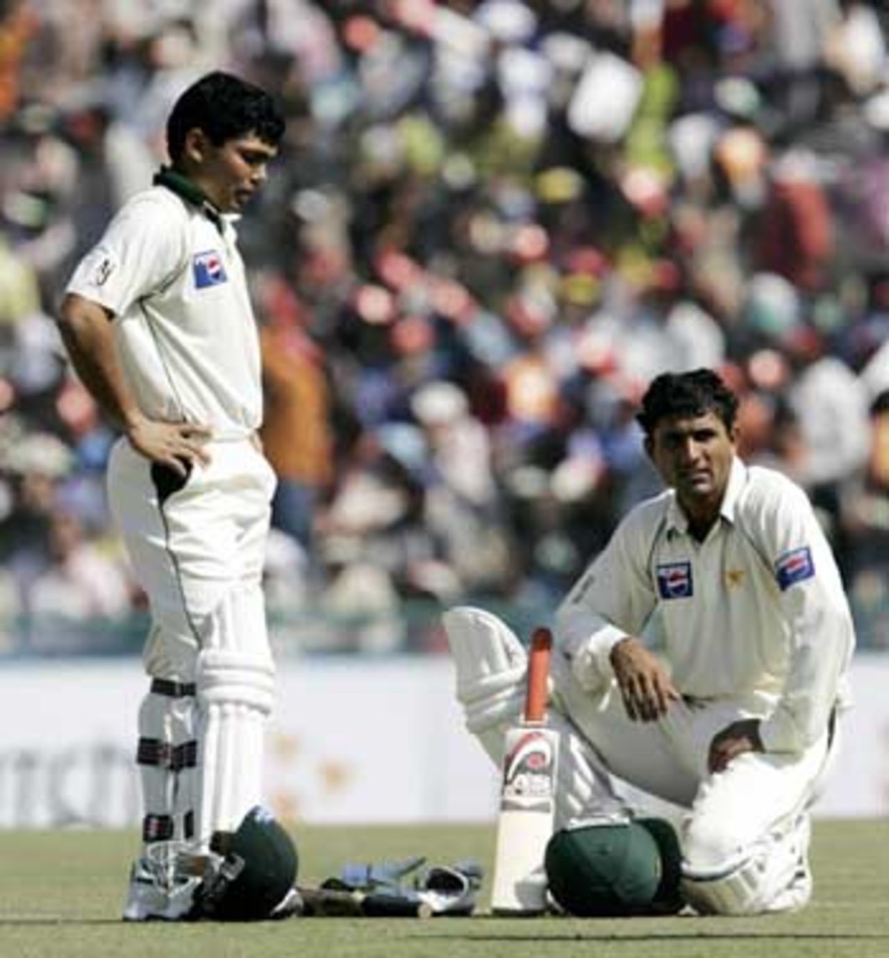 Abdul Razzaq and Kamran Akmal took time to catch their breath in the middle of a match-saving partnership, India v Pakistan, 1st Test, Mohali, 5th day, March 12, 2005