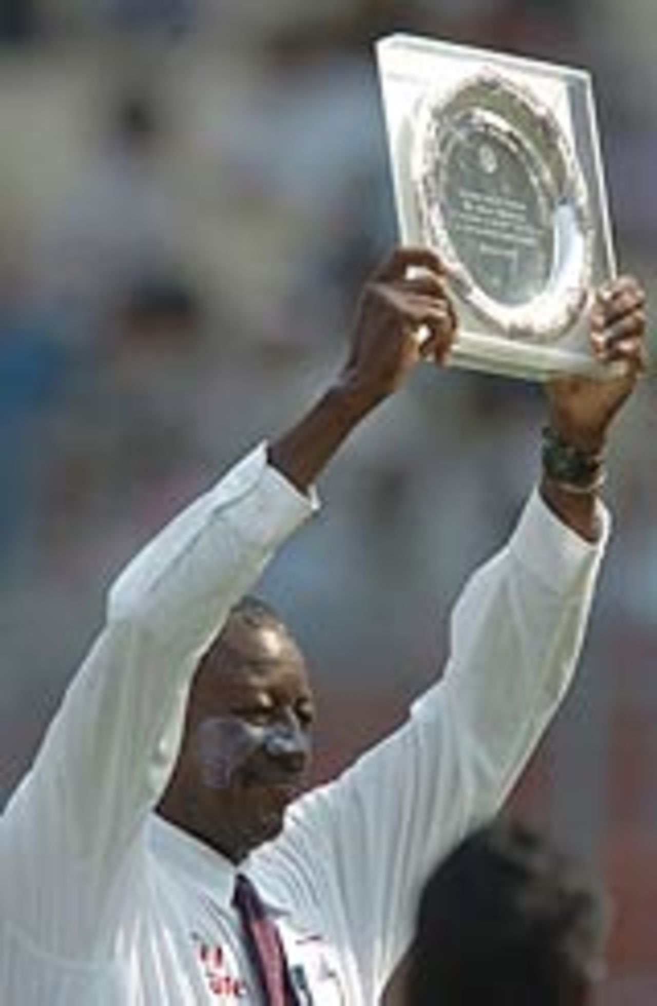 Steve Bucknor holds the plaque presented on occassion of his 100th Tests, India v Pakistan, 2nd Test, Kolkata, 1st day, March 16, 2005