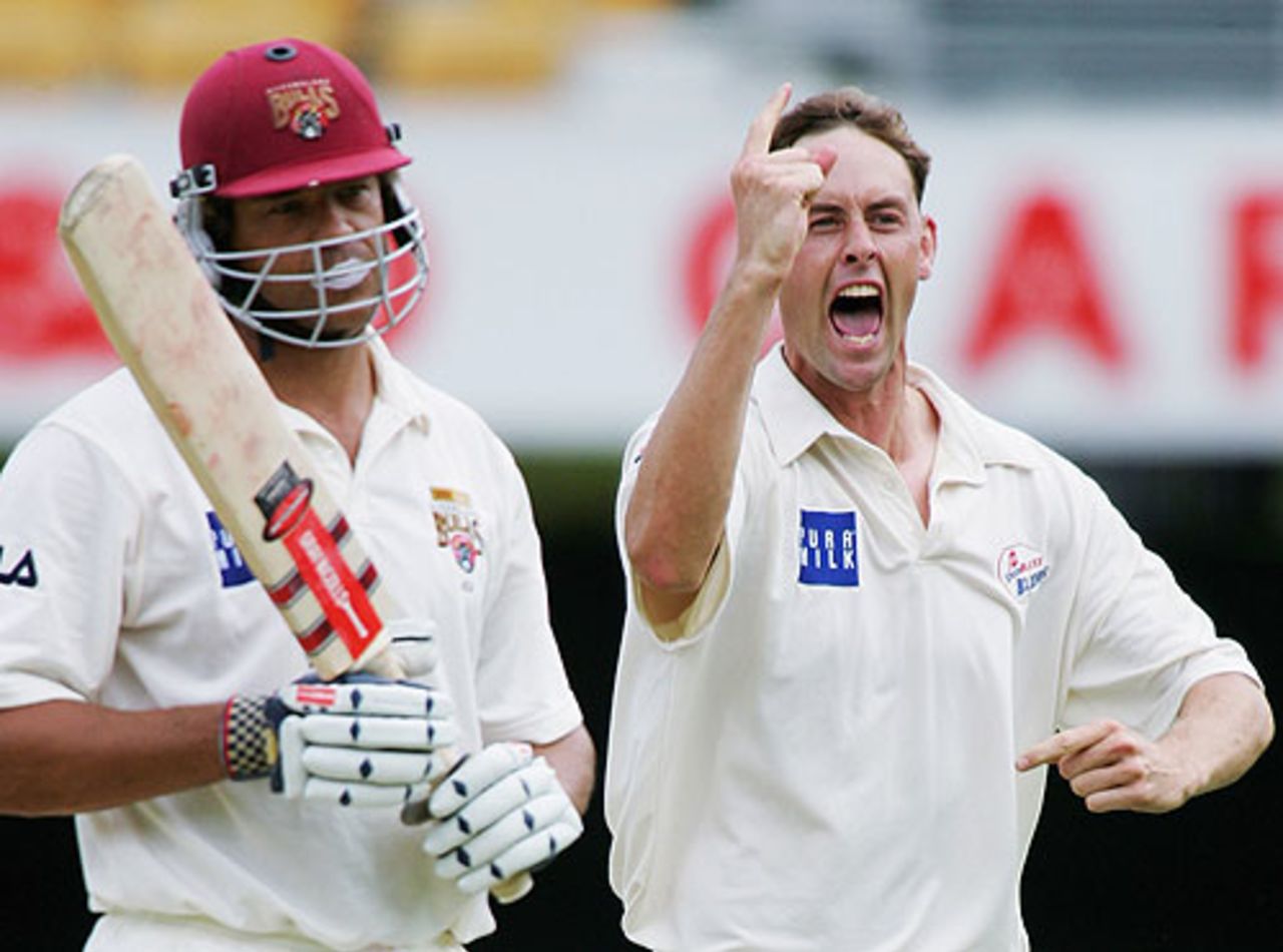 Matthew Nicholson celebrates as Andrew Symonds troops off, Queensland Bulls and New South Wales Blues, Gabba, March 18, 2005