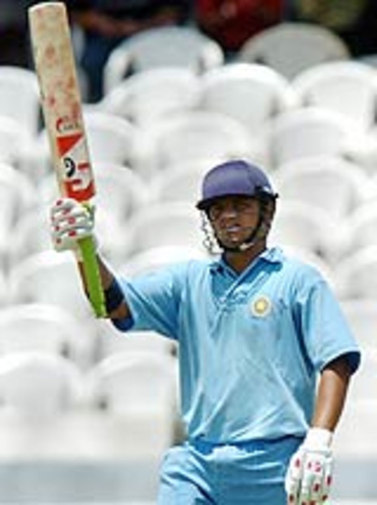 Suresh Raina raises his bat after reaching his fifty in Pakistan's warm-up against India A, Hyderabad, March 30, 2005