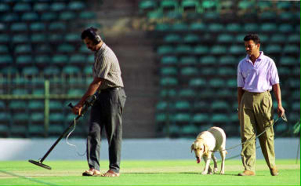 A bomb detection squad scan the cricket pitch with sniffer dogs and other gadgets, 03 March in Chinaswany cricket stadium ,in Bangalore on the eve of the final for the Triangular One-day cricket series to be played between India and Pakistan