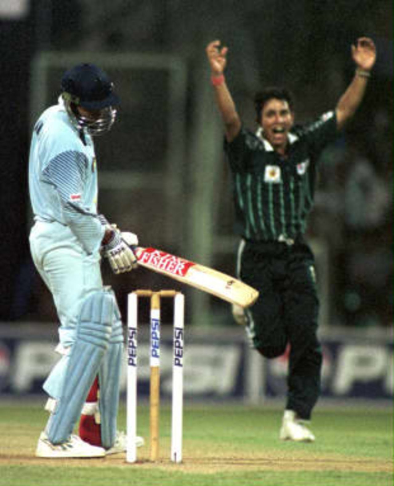 Pakistani bowler Azhar Mahmood jubilates after getting Indian batsman and team captain Ajay Jadeja out in the final of the Triangular Cricket series between India and Pakistan 04 March 1999, in Chinaswamy cricket stadium, in Bangalore. Azhar Mahmood went on to take 5 Indian wickets to become the man of the match.