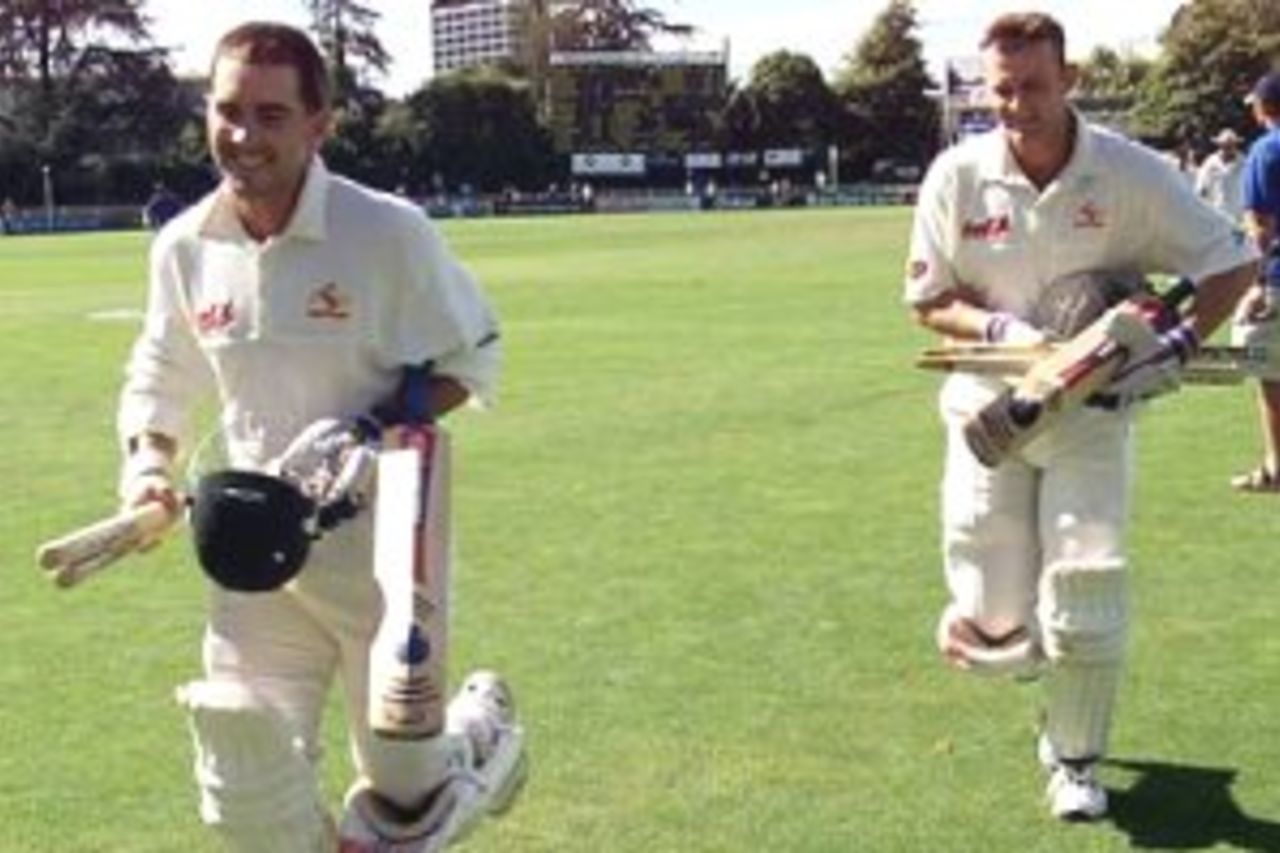 03 Apr 2000: Justin Langer of Australia leads team mate Adam Gilchrist from the field as Australia wins the test, during day four of the third test between New Zealand and Australia, at WestpacTrust Park, Hamilton, New Zealand. Australia won by six wickets.