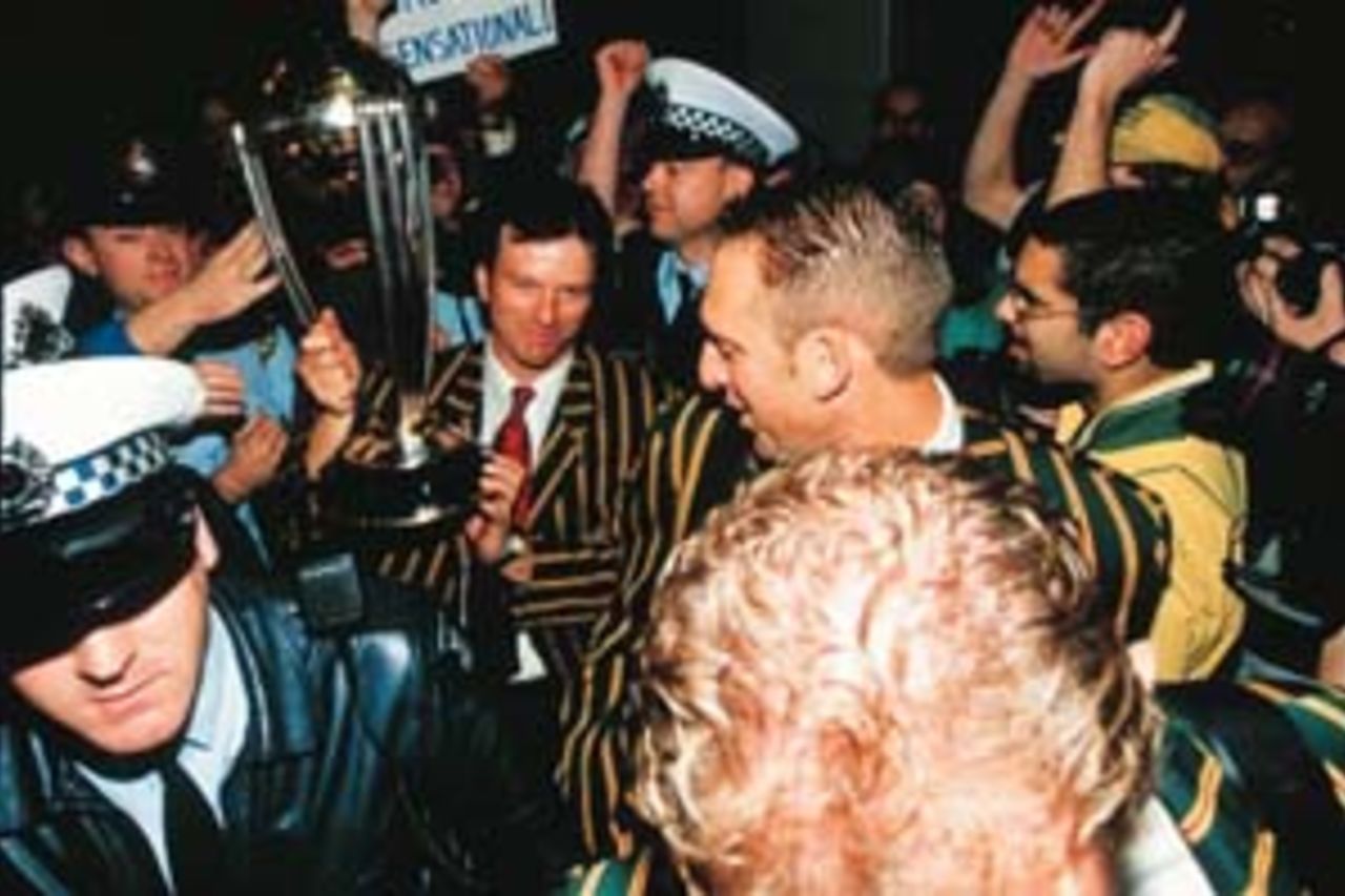23 Jun 1999: Steve Waugh, Australian cricket captain, heads for the team bus with the World Cup trophy on return home with the Australian team after their victory over Pakistan in the 1999 Cricket World Cup Final at Lords Cricket Ground, London. The players arrived at Melbourne Airport, Melbourne, Australia.