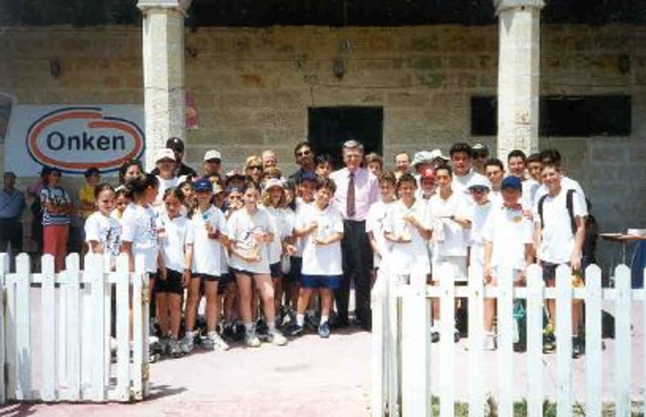 Group photograph of school kids plus the British High Commissioner (pink shirt) ar Kwik-Cricket inter-schools tournament at Marsa