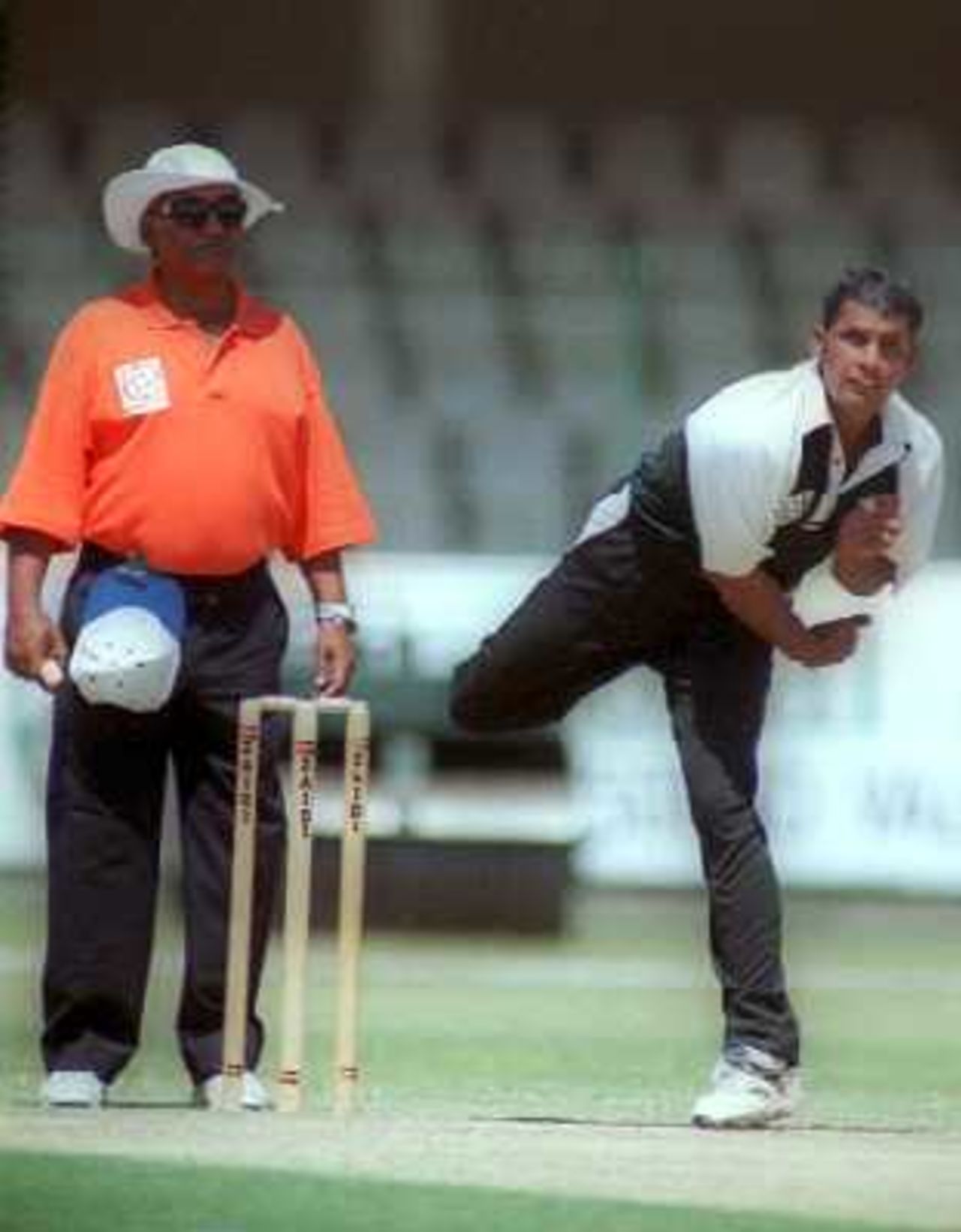 Off-spinner Murtaza Hussain of KRL in action during the 1st semi-final of NBP Cup against Wapda at Lahore's Gaddafi Stadium. 9 April 2000.