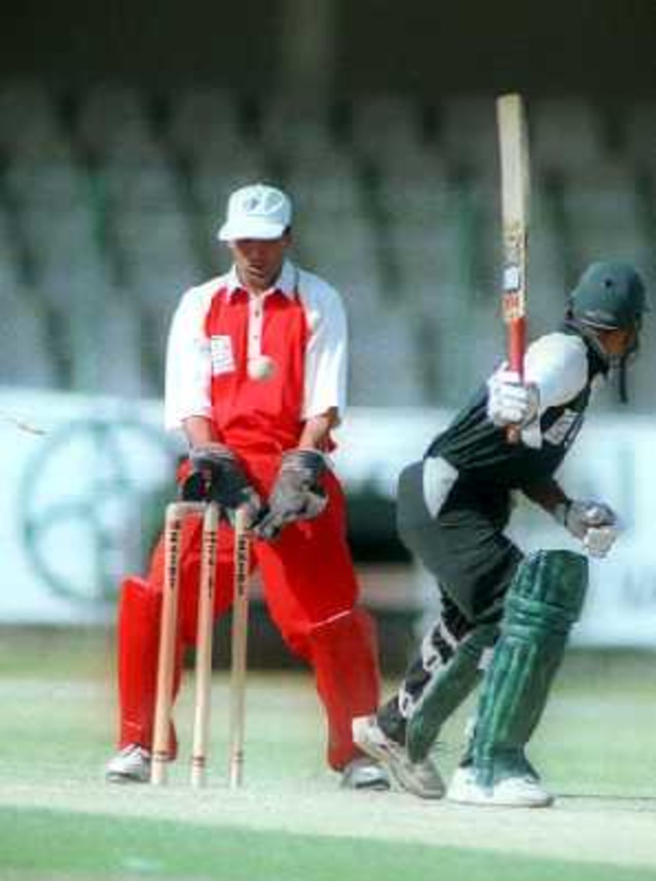 Saeed Anwar Junior of KRL is bowled by Wapda's Sarfraz Ahmed during the 1st semi-final of the NBP Cup at Lahore's Gaddafi Stadium. 9 April 2000.