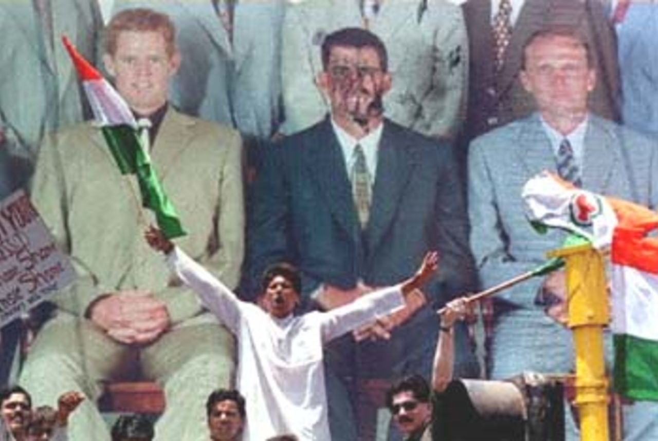 Youth Congress activists shout slogans after desecrating the face of disgraced South Africn cricket captain Hansie Cronje, seen here on a billboard advertisement for men's suits together with his teammates, 12 April 2000 in Bombay. Cronje was sacked by the South African Cricket Board for accepting sums of $10,000 and $15,000 for matching fixing in a recent triangular series held in India. Hansie will be tried in India and if found guilty will face four years of jail in India.