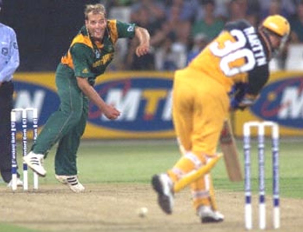 South African bowler Jacques Kallis (L) delivers a ball to Australian batsman Damien Martyn during a ODI match at the Kingsmead oval in Durban 12 April 2000. South African Makhaya Ntini has taken four wickets as the first three one day match series got under way and South Africa is currently 218 for 7