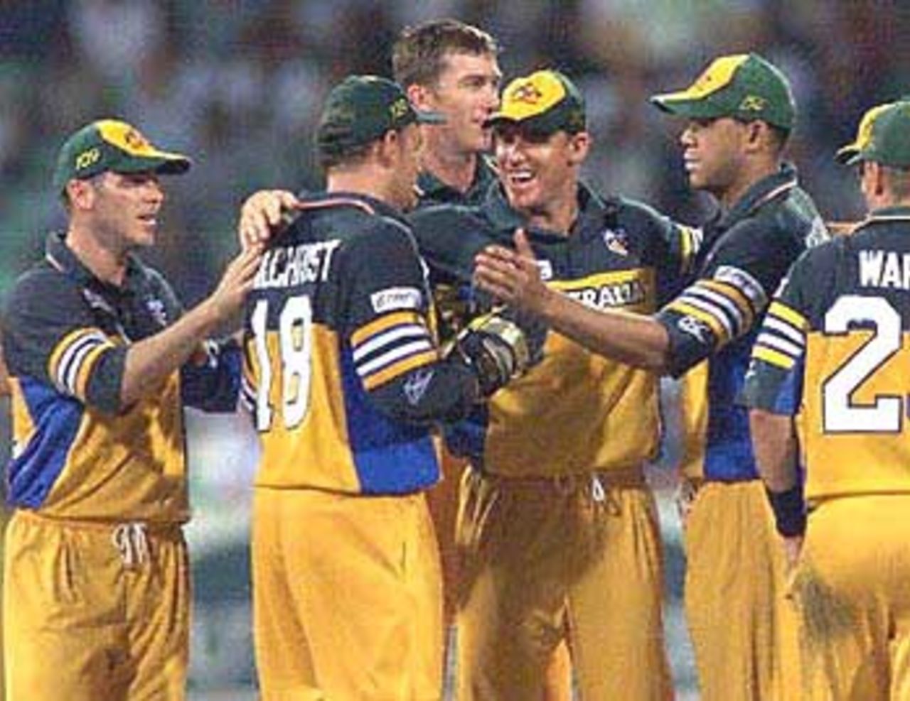 Australian wicketkeeper Adam Gilchrist (2nd L) is congratulated by teammates after catching South African batsman Jaques Kallis and dismissing him for 51 runs during a ODI match at the Kingsmead oval in Durban, 12 April 2000.