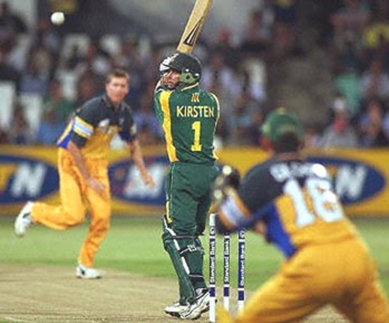 South African bowler Gary Kirsten (C) hits a ball from Glenn McGrath (L) of Australia during a one day internatonal match at the Kingsmead oval in Durban, 12 April 2000.